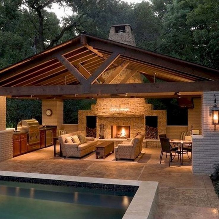 outdoor living space with kitchen, fireplace, couches and a roof
